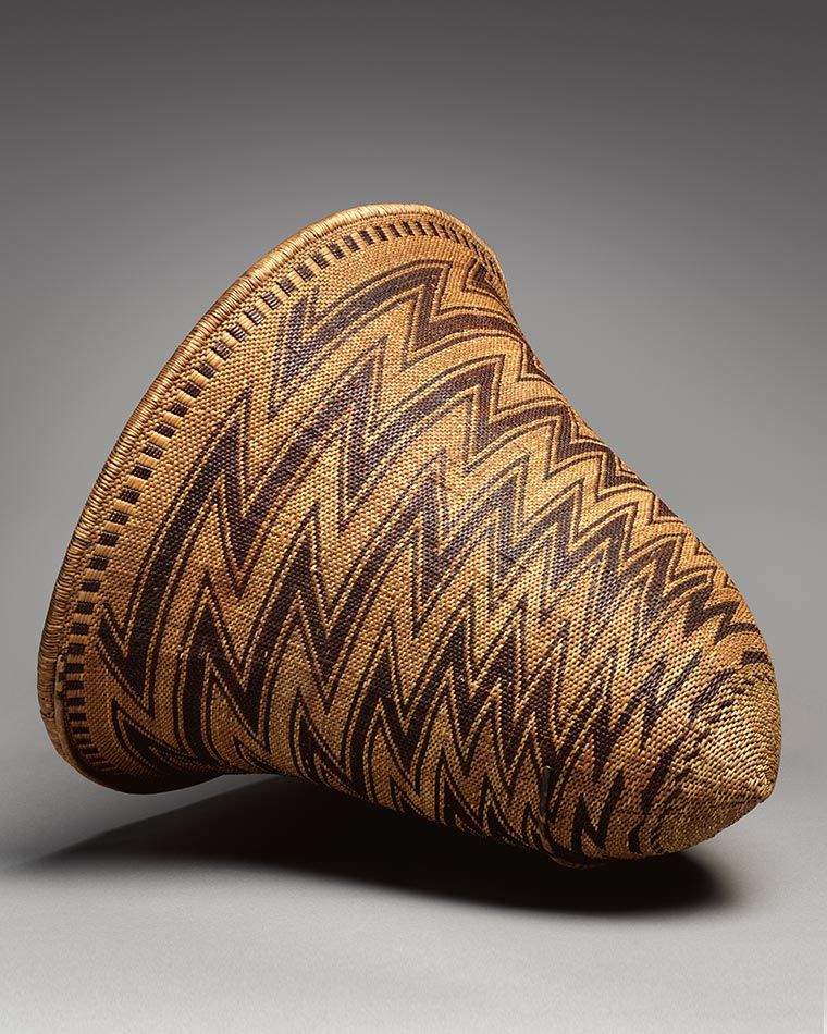 cm).  Gift of Charles and Valerie Diker, 2016 (2016.738.1) A large light brown basket shaped like a cone and featuring sharp zig zags in dark brown circling its diameter.